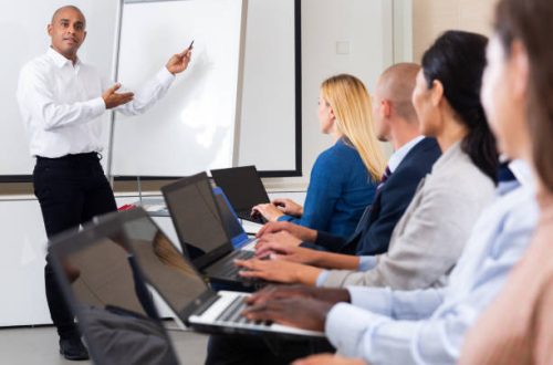 latino male instructor explained something to students in meeting room